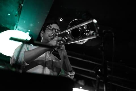 image of Joe playing trombone at a jazz club